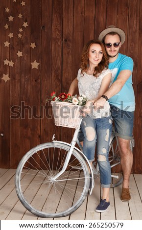 Couple sitting on the one bike hugging and smiling.girl lucky guy on a bike