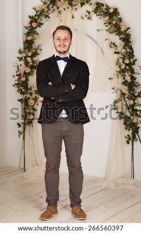 cheerful guy in a classic suit and bow tie