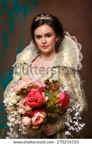 queen in royal dress.Princess holding a large bouquet of flowers.