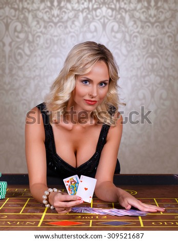 girl holding the winning combination of poker cards.Girl playing in casino.