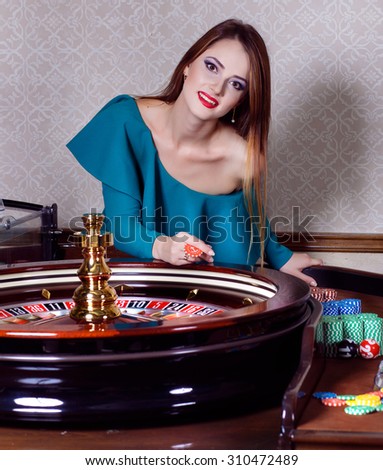 Girl playing in casino.Woman winning in a casino