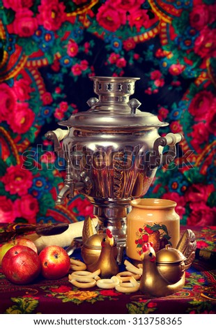 Traditional Russian tea from Samovar. still life with samovar, flowers and apples