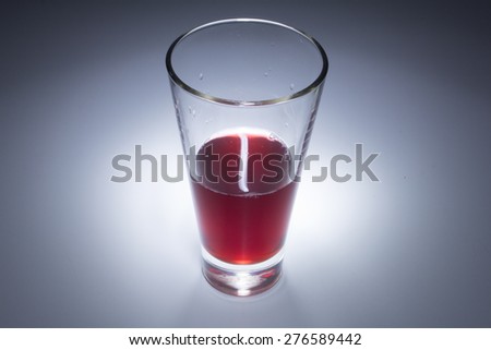 Glass with red liquid, red juice