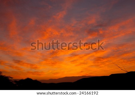 Desert sky at sunrise with red clouds