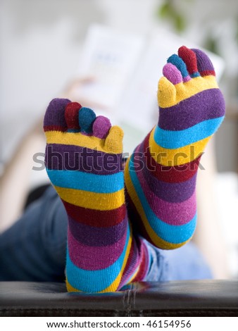 woman reading a magazine in funny socks