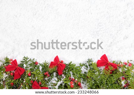 Christmas border with traditional decorations on the snow. Space for copy.