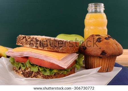 School lunch on classroom desk with sandwich