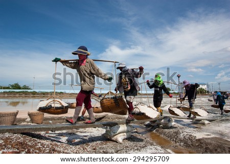 Samutsakhon,Thailand - May 17: Thai people keeping salt from Salt farming or Salt evaporation pond to godown on May 17 ,2015 in Samutsakhon Thailand.