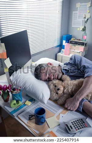 Funny office worker sleeping in the office overnight with teddy bear.