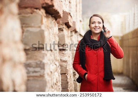 Young woman having a relaxing walk and talking on the phone