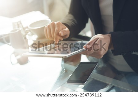 Businesswoman at the bar working on a tablet hands close up