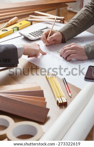 Businessman and construction engineer working together, the customer is pointing on the project on the desk