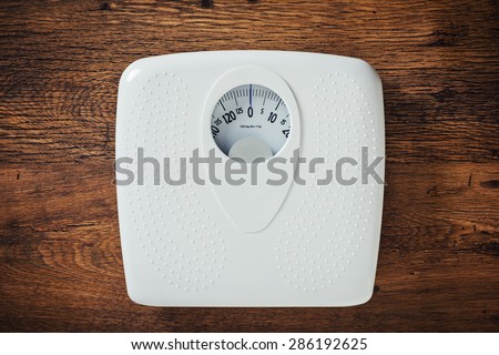 White scale on a wooden table top view, fitness and weight loss concept