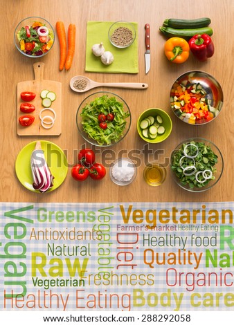 Healthy fresh vegetarian food on kitchen table with healthy eating text concepts on a checked tablecloth, top view