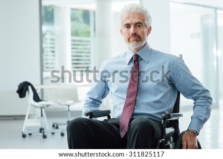 Successful confident businessman in wheelchair smiling at camera, career and disability overcoming concept