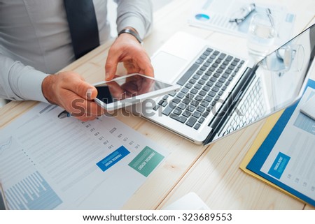 Professional businessman working at desk and using a touch screen tablet, technology and communication concept
