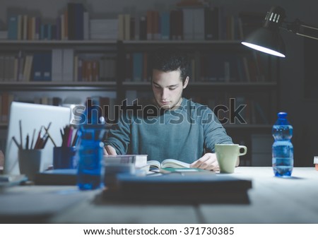 Teenage student reading books and studying late at night, learning and education concept