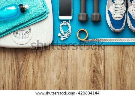 Training and sports equipment on a mat and weight scale, healthy lifestyle and workout concept, flat lay banner