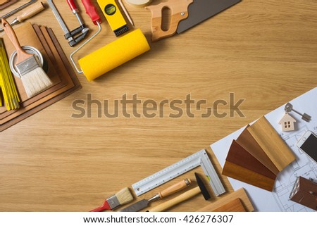 Do it yourself home remodeling and renovation concept, work table top view with tools, house keys and wood swatches