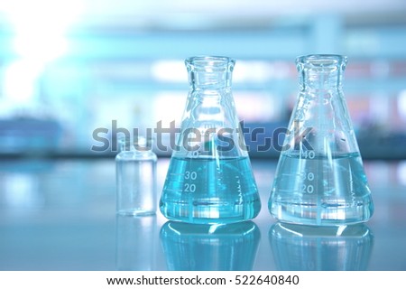blue glass flask in science lab for research background