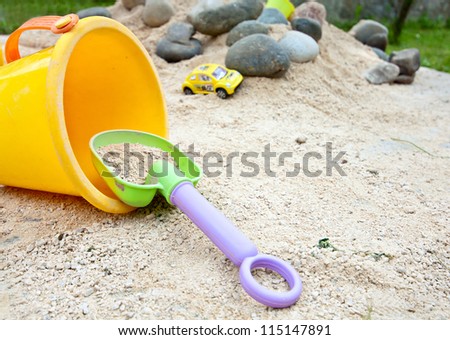 child fun play game with bucket and sand