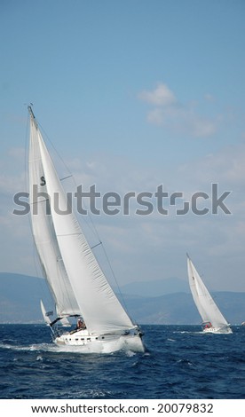 two white yachts sail in the sea