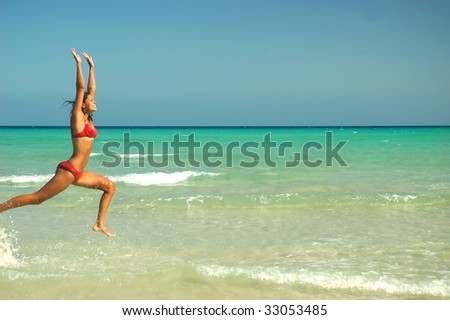 women jump at water