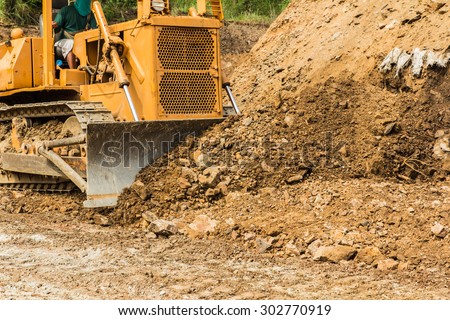 industrial  bulldozer moving earth and sand in sand pit or quarry