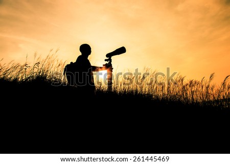 The Silhouette man whit camera gear at sunset