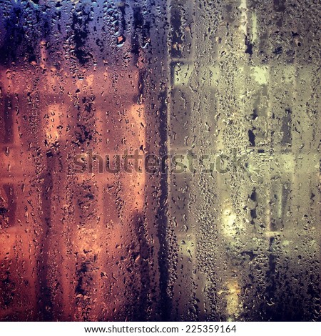 Condensation accumulated on a pane of glass or window.