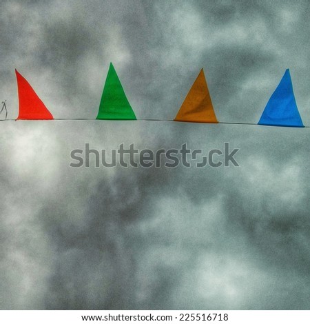 Colored triangle bunting points upwards towards the sky.