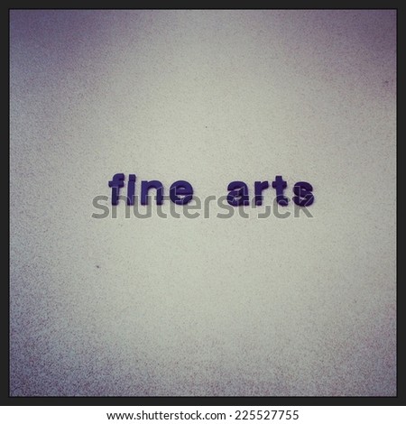 Some blue letters on a white background spelling fine arts.