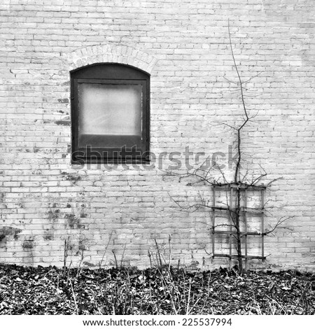 A small window in the side of an old brick building.