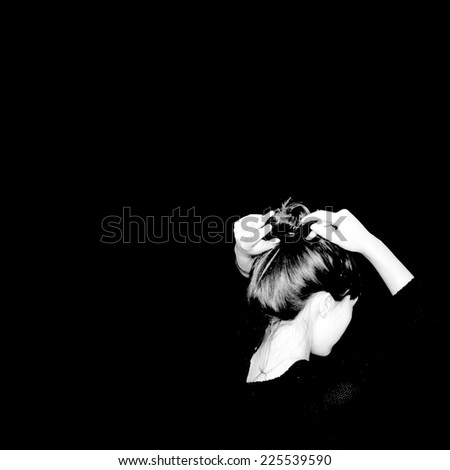 A black background with a reverse silhouette of a woman\'s skin and hair.