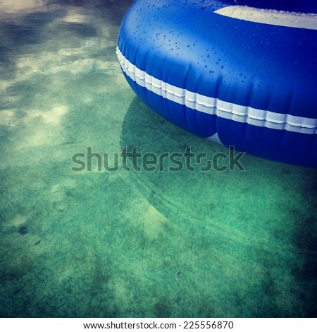 A blue, plastic raft floating on calm water.