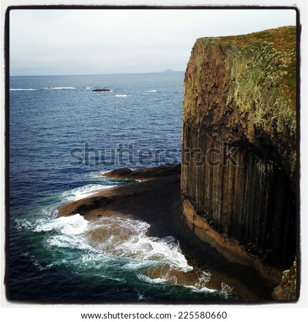 A sheer cliff edge next to the ocean.