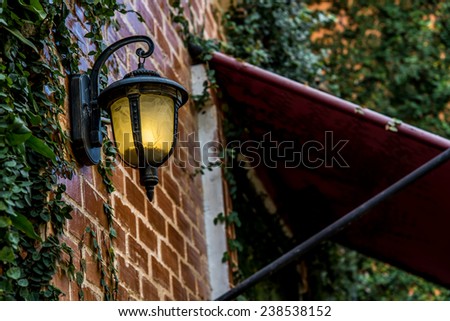 wall lamp on the brick wall outside the house