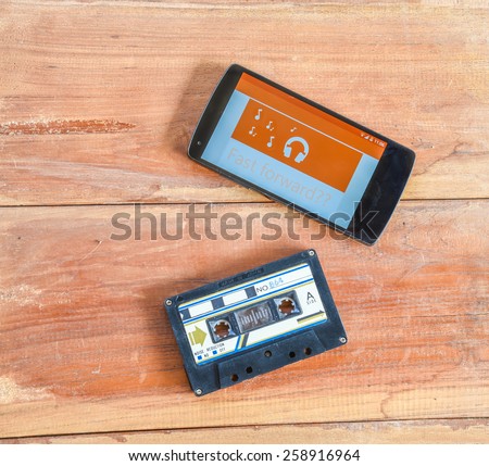 concept of difference technology ,picture of smart phone  and old cassette tape