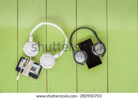 Smartphone cassette tape and headphone on the wood board
