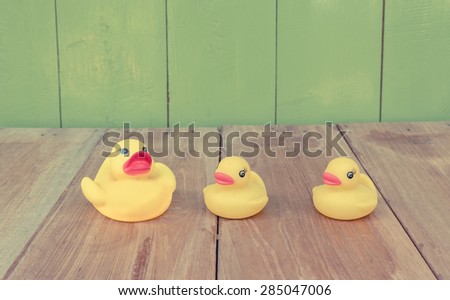 yellow duck on wood board