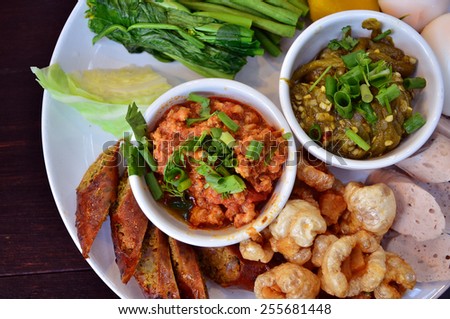 Northern Thai food. Lanna Food. Thai sausages, steamed eggs, deep fried pork skin, steamed vegetables, and spicy chilly paste (Namprik Noom).