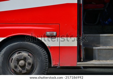 Close up of wheel and door of the red bus. Side view. Retro bus.