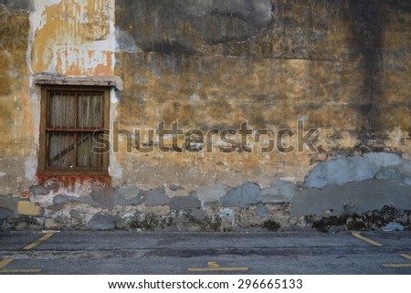 Old house wall with wooden window.