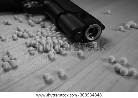 Close up of pistol. 11 mm or 0.45 and BB gun bullet. Black and White. Shallow depth of field.