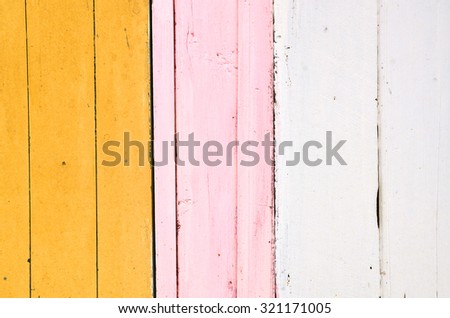 Yellow, pink and white wooden background with vertical stripes. Vintage old backdrop. Pastel color.