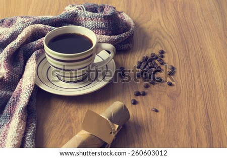 Warm cup of coffee on wood background