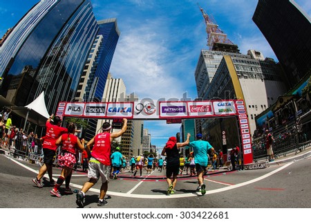 SAO PAULO, BRAZIL - DECEMBER 31, 2014: Athletes crosses the finish line in the Sao Silvestre Road Race at the famous Avenida Paulista