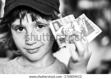 Cute boy plays with money
