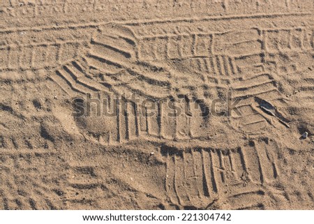 Ribbed human traces on dry sand. Background for articles about traveling, transport and ecology