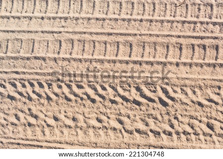 Ribbed tyre traces on dry sand. Background for articles about traveling, transport and ecology